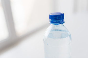 Image showing close up of bottle with drinking water on table