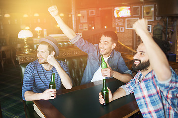 Image showing happy male friends drinking beer at bar or pub