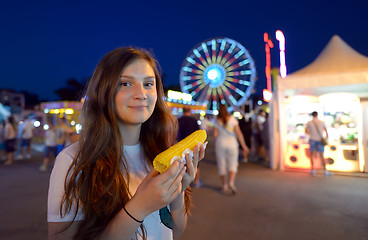 Image showing teen girl eating corn