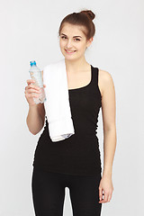 Image showing Beautiful girl with towel and bottle of water