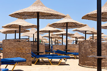 Image showing Beach umbrellas and blue sky background