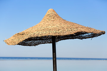 Image showing Beach umbrella and blue sky background