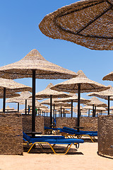 Image showing Beach umbrellas and blue sky background