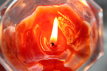 Image showing Orange burning candle