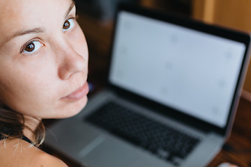 Image showing Woman working on computer and looking at the camera