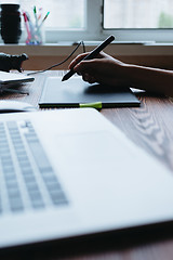 Image showing Girl the designer draws on the graphic tablet