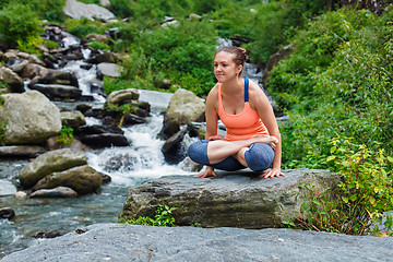 Image showing Woman doing  Ashtanga Vinyasa Yoga  arm balance asana Tolasana