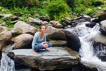 Image showing Woman doing  Ashtanga Vinyasa Yoga  arm balance asana Tolasana