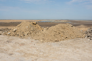 Image showing Two heaps of earth with a small amount of construction waste