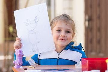 Image showing Vityazevo, Russia - April 24, 2016: Girl painted Luntik at a table in the garden