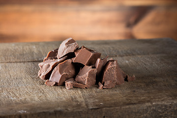 Image showing Pieces of milk Chocolate on wood