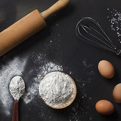 Image showing flour and ingredients on black table