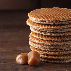 Image showing Waffles with caramel on wood