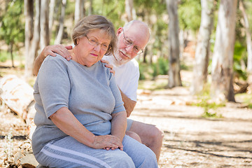 Image showing Upset Senior Woman Sits With Concerned Husband Outdoors