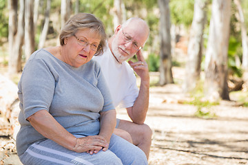 Image showing Upset Senior Woman Sits With Concerned Husband Outdoors