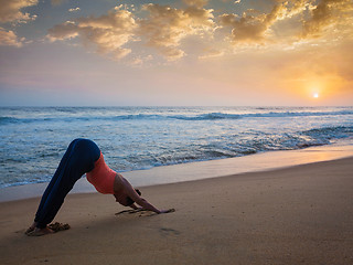 Image showing Woman doing yoga Surya Namaskar oudoors at tropical beach