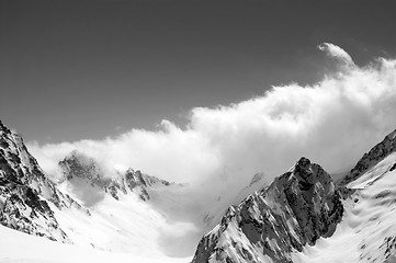 Image showing Black and white winter snowy mountains in cloud