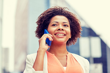 Image showing happy african businesswoman calling on smartphone