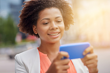 Image showing happy african businesswoman with smartphone