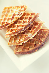 Image showing close up of waffles on plate at breakfast table