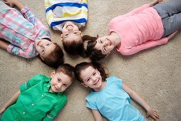 Image showing happy smiling little children lying on floor