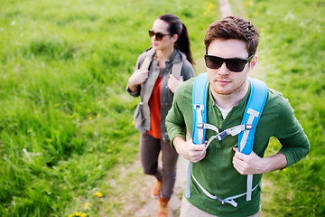 Image showing couple with backpacks hiking outdoors