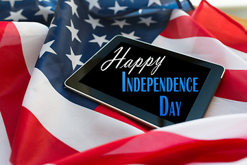 Image showing happy independence day on tablet pc american flag