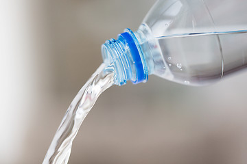 Image showing close up of water pouring from plastic bottle