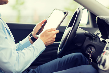 Image showing close up of young man with tablet pc driving car