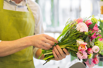 Image showing close up of man making bunch at flower shop