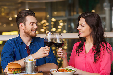 Image showing happy couple dining and drink wine at restaurant