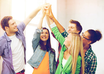 Image showing happy students giving high five at school