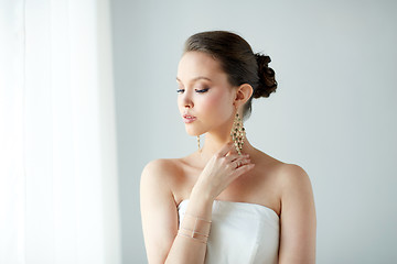 Image showing beautiful asian woman with earrings and bracelet