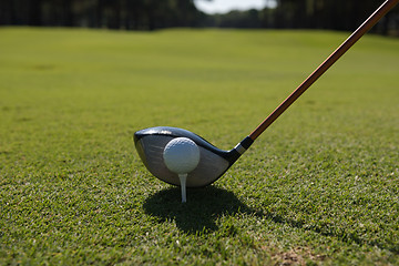 Image showing golf player placing ball on tee