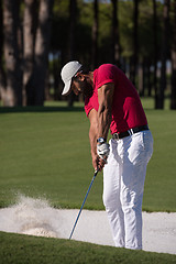 Image showing golfer hitting a sand bunker shot