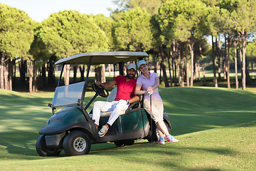 Image showing couple in buggy on golf course