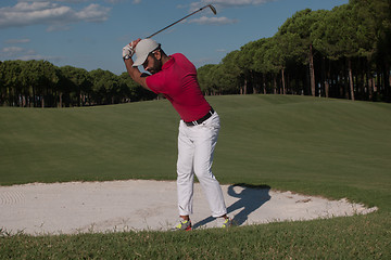 Image showing golfer hitting a sand bunker shot