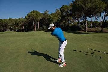 Image showing golf player hitting shot