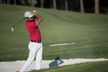 Image showing golfer hitting a sand bunker shot