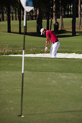 Image showing golfer hitting a sand bunker shot