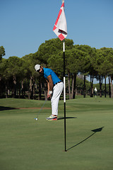 Image showing golf player hitting shot at sunny day