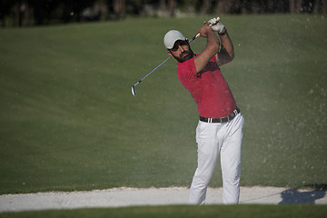 Image showing golfer hitting a sand bunker shot