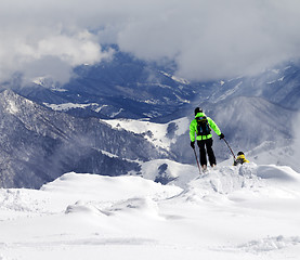 Image showing Freeriders on off-piste slope and mountains in mist