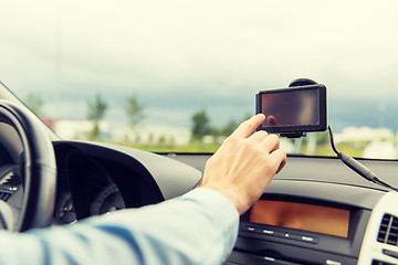 Image showing close up of man with gps navigator driving car