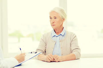 Image showing doctor with clipboard and senior woman at hospital