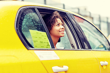 Image showing happy african american woman driving in taxi