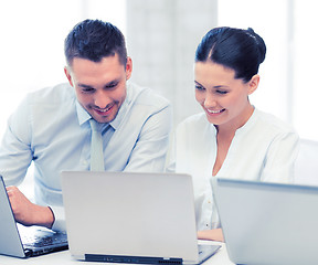 Image showing group of people working with laptops in office