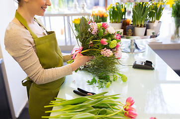 Image showing close up of woman making bunch at flower shop