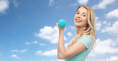 Image showing smiling beautiful young sporty woman with dumbbell