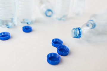 Image showing close up of empty water bottles and caps on table